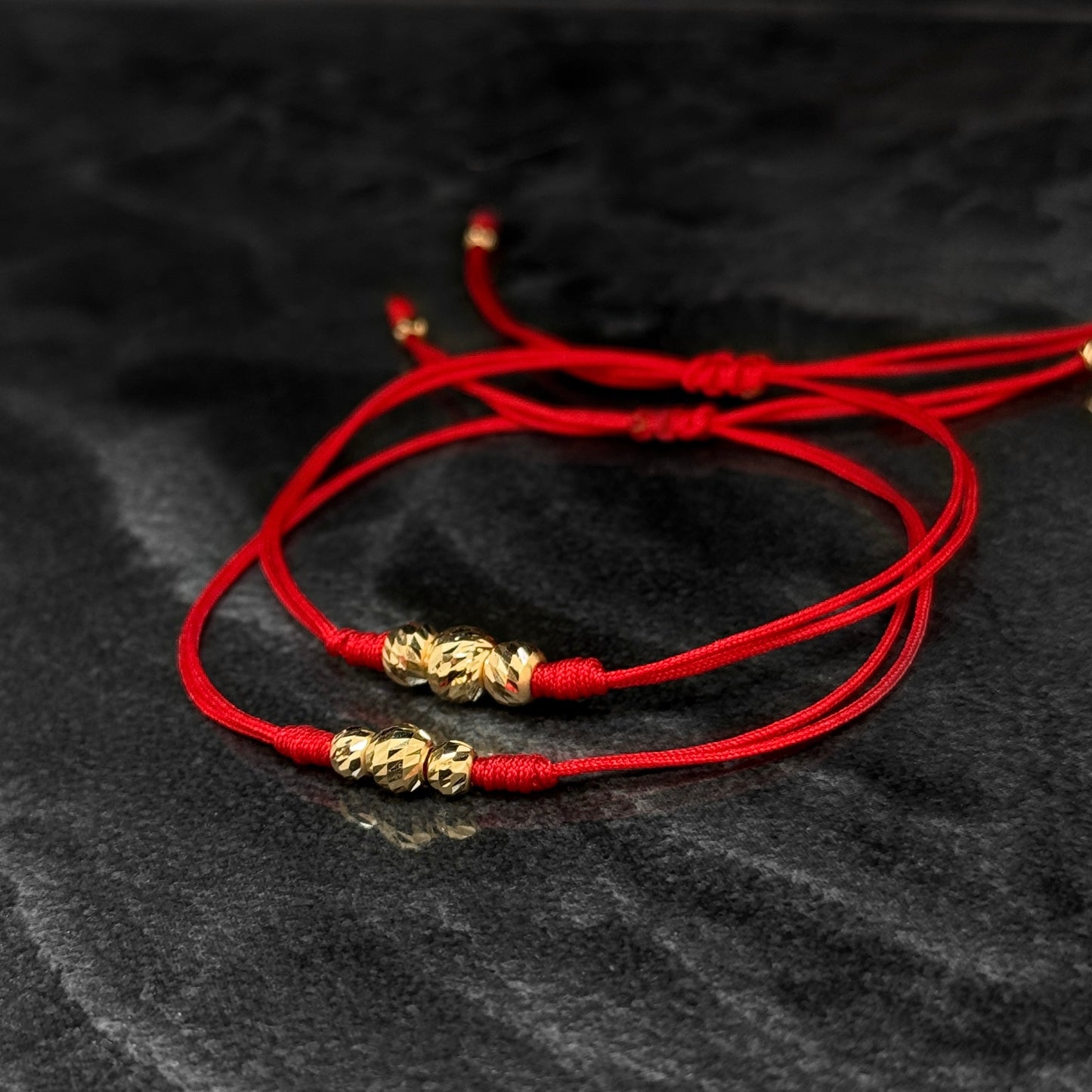 Dúo Pulseras Tejidas / Balines Oro 18K