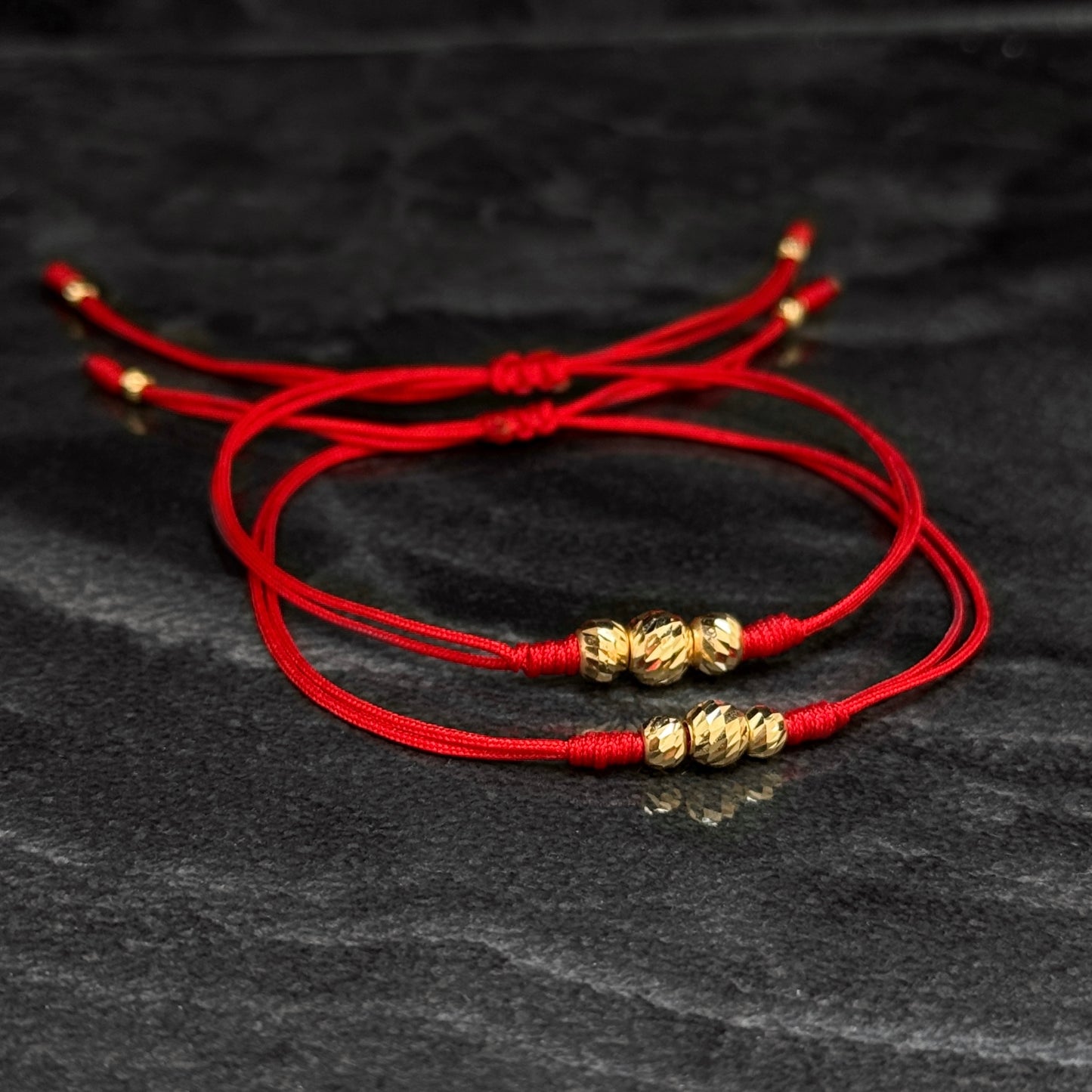 Dúo Pulseras Tejidas / Balines Oro 18K